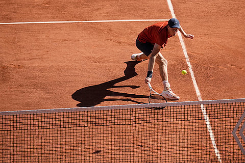 Jannik Sinner plays a shot against Carlos Alcaraz